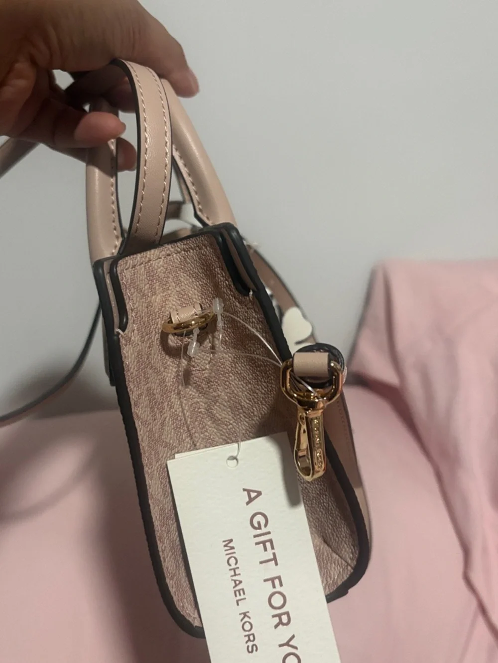 A cute MICHAEL KORS Blush Pink Logo Satchel with Floral Charm